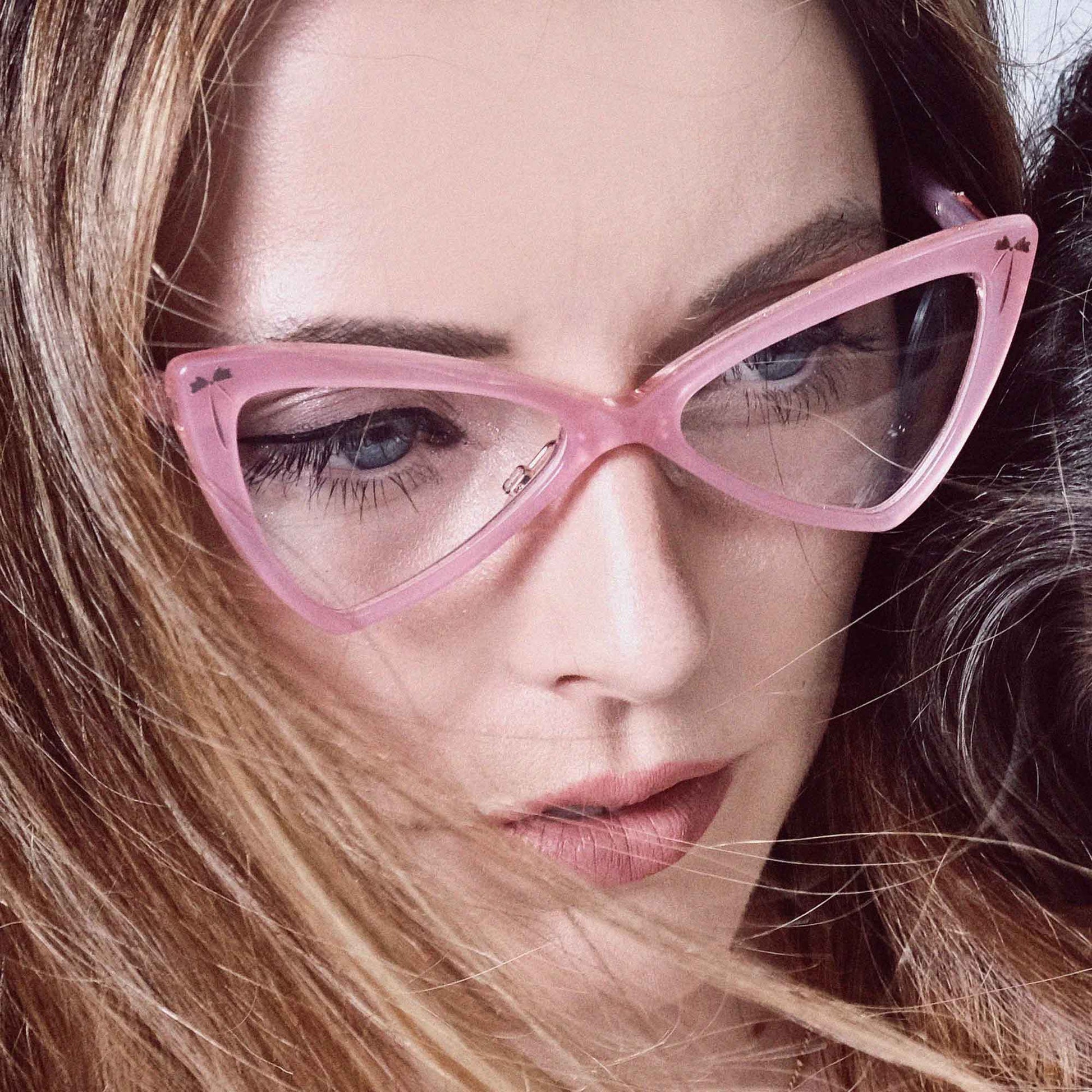Women wearing pink cat eye glassse frames