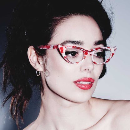 Woman wearing red and white marble cat eye glasses